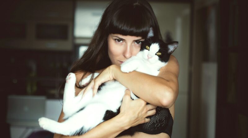 woman carrying cat