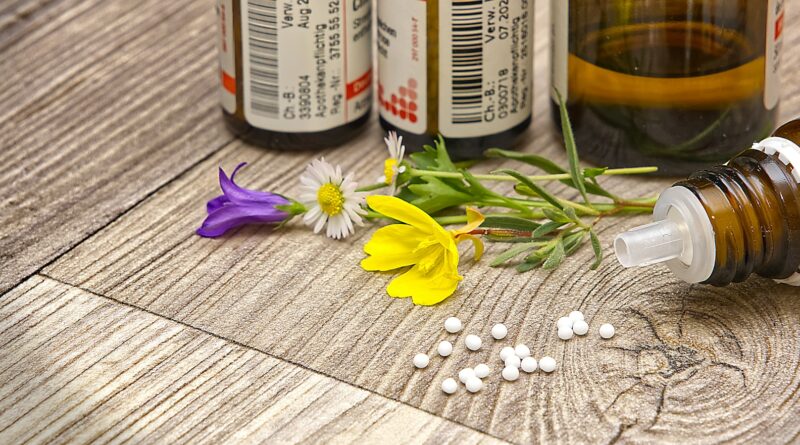 A bottle of medicine sitting on top of a wooden table